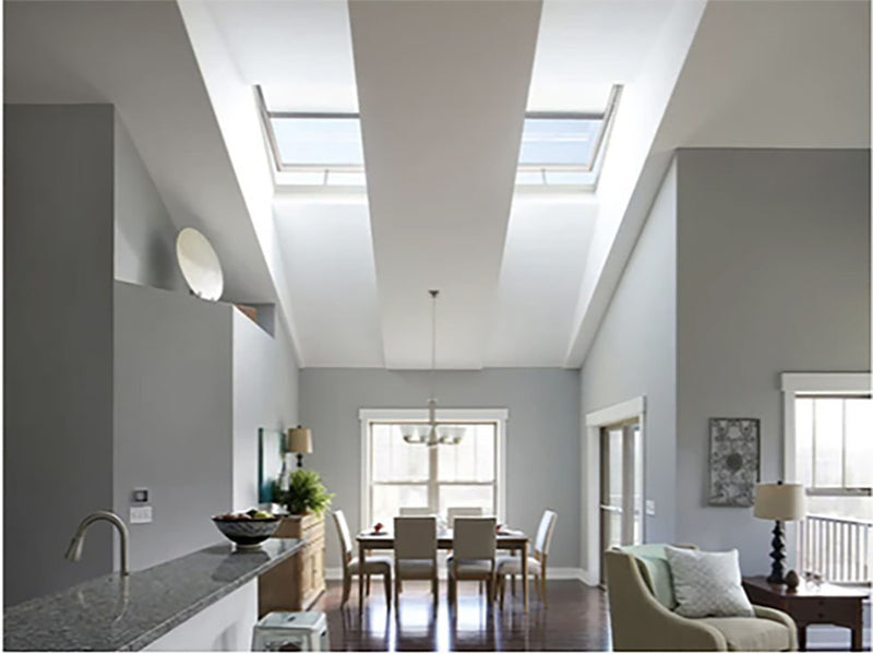a living area and kitchen with skylights